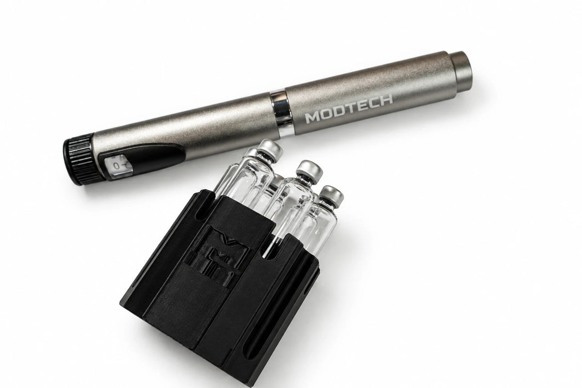 Silver MODTECH V2 pen beside a black purge station holding 3 mL glass cartridges