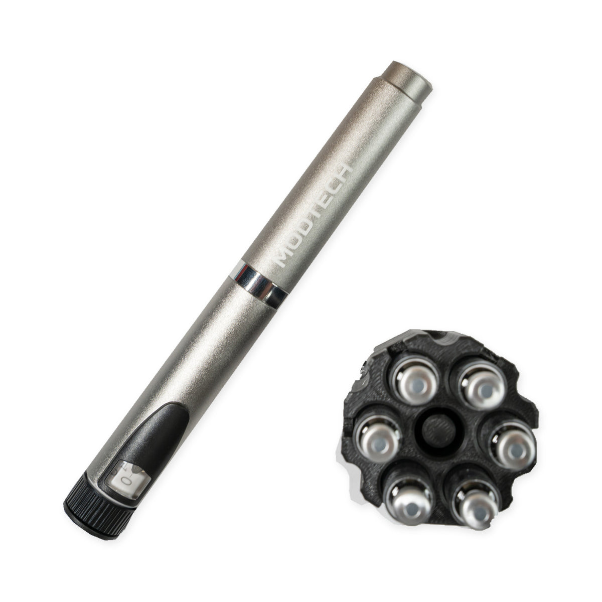 Silver MODTECH V2 pen beside the purge station seen from above: six 3 mL cartridges in the slots around the center purge post