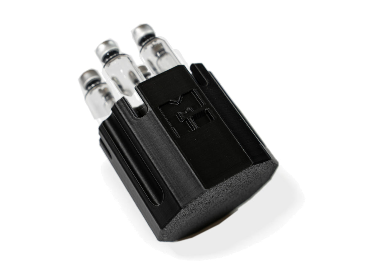 MODTECH purge station holding 3 mL glass cartridges, seen from the front with the M logo